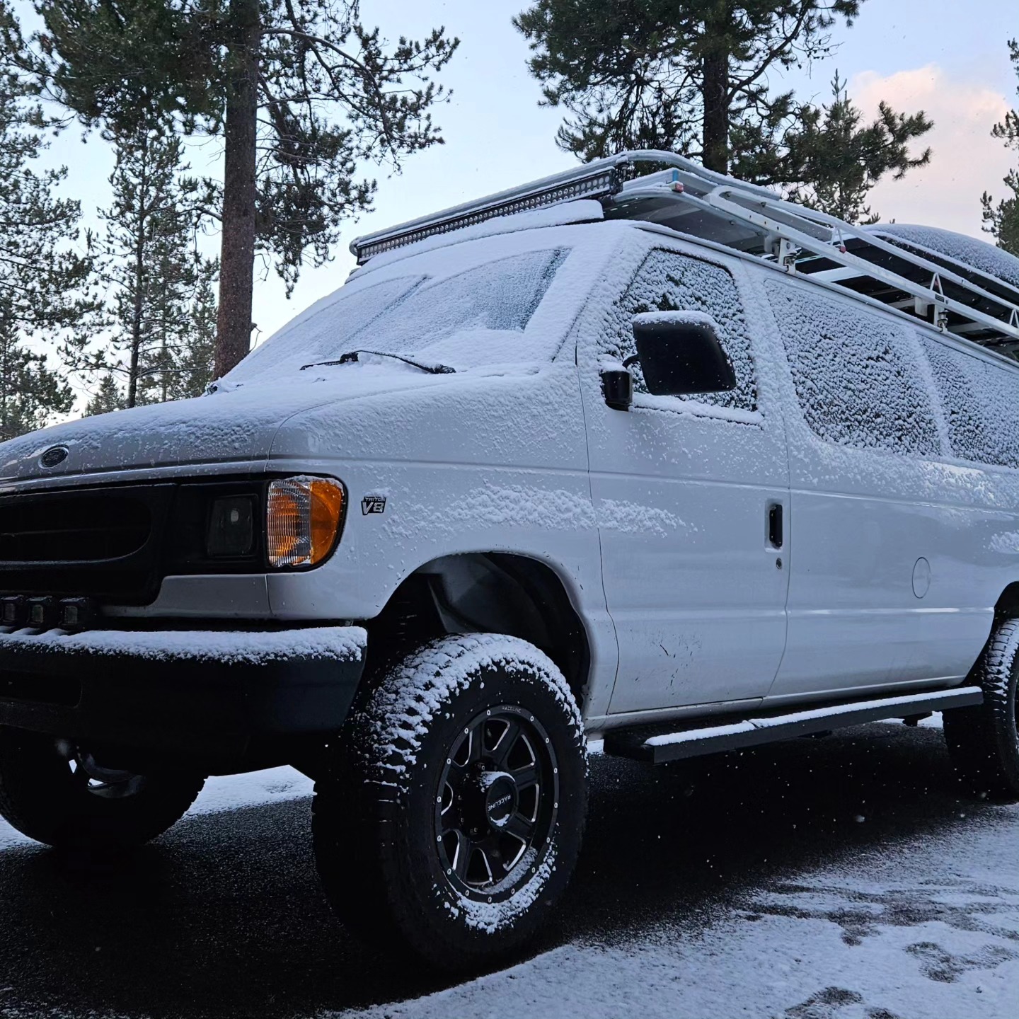 The lifted white E-Series dusted in fresh snow